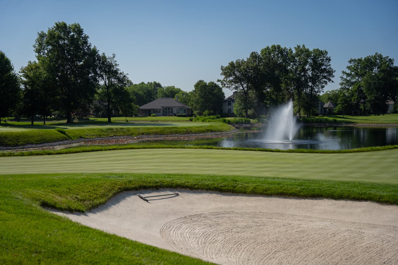 Greenside bunker beside a water fountain at a private course