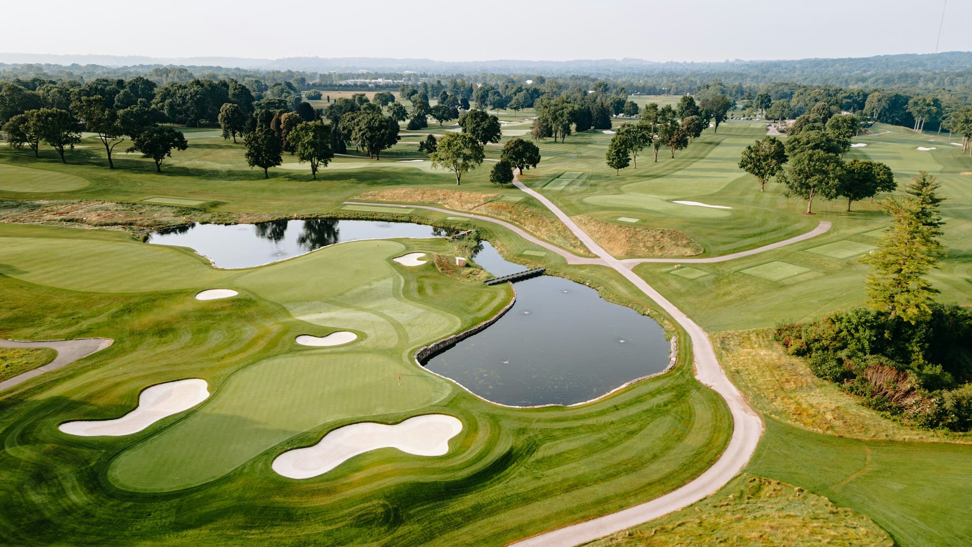 Golf course at sunset with pine-lined fairway